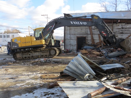 excavator tearing down building