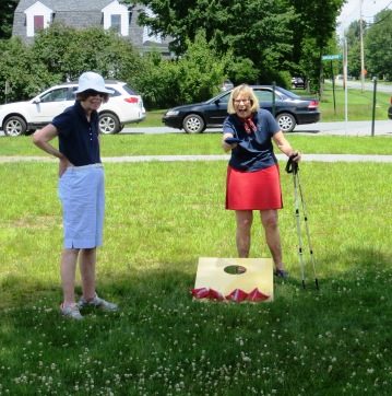 women playing bean bag toss