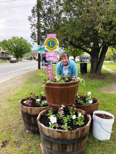 one woman with three barrels of flowers