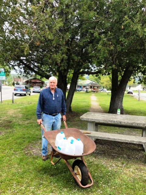 man pushing wheelbarrow