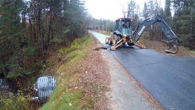 backhoe repairing culvert