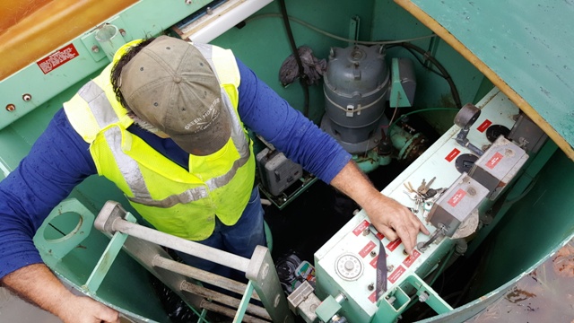 water operator working on pump for water and sewer system