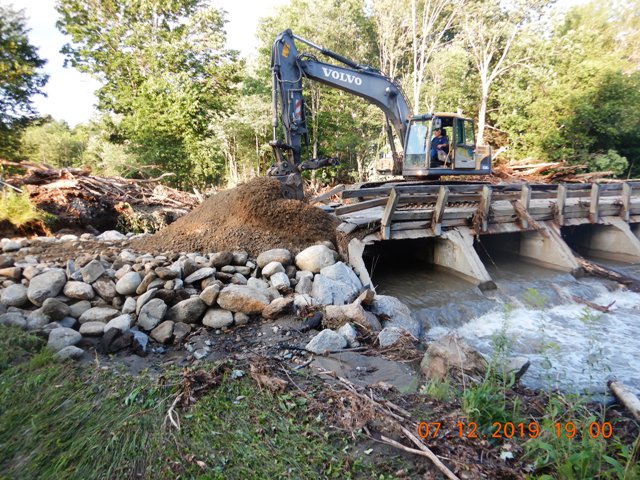 backhoe repairing bridge