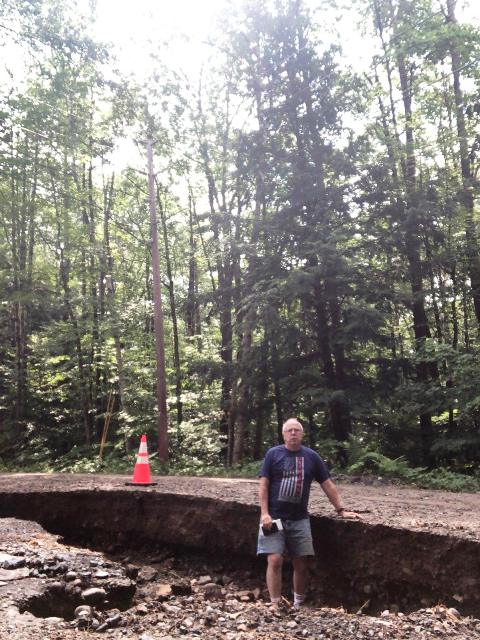 man waist deep in damaged ditch
