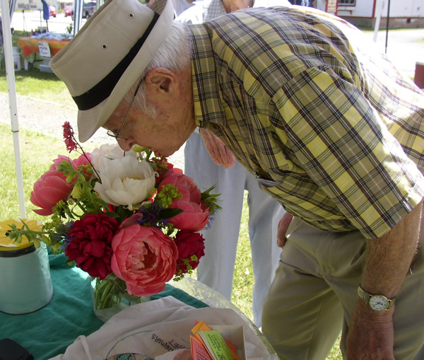 Man smelling Farmers Market flowers