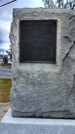 memorial stone set with bronze plaques of veteran names