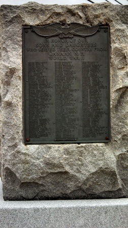 memorial stone set with bronze plaques of veteran names