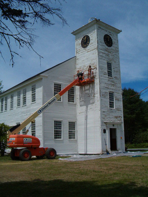 painting the bell tower from a lift