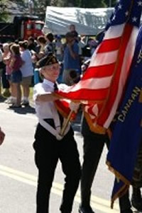 woman carrying billowing American flag