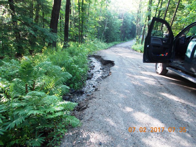 water running through eroded ditch