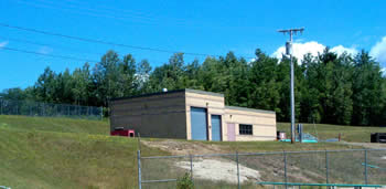 Block-like building with blue garage doors.