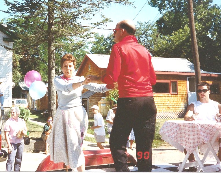 Brent & Gloria Stevens dancing on a 50s diner parade float