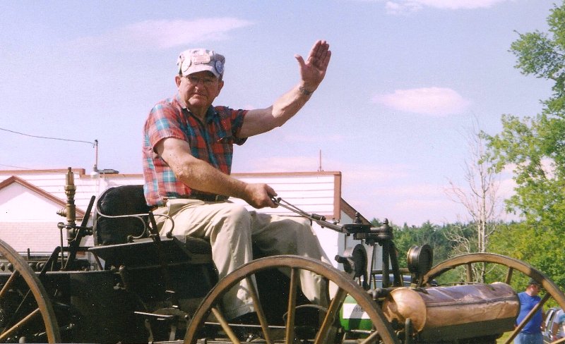 early car driver waving