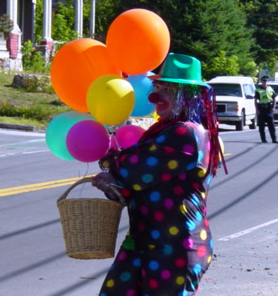 clown carrying balloons and a basket