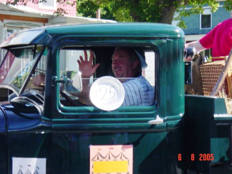 man waving from old truck