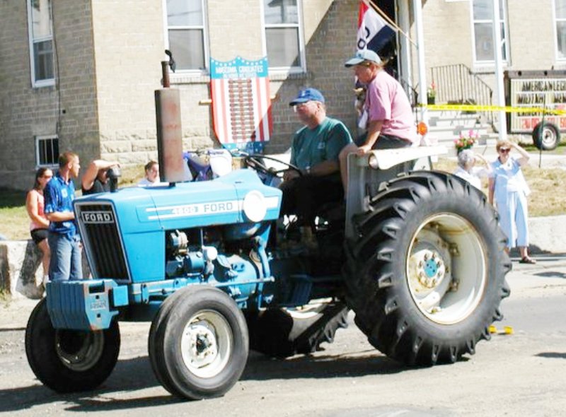 2 men on a ford tractor