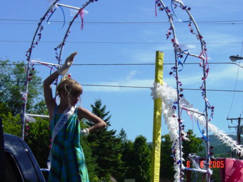 girl waving from float