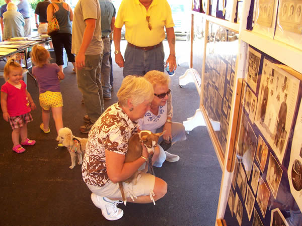 alumni looking at old photos