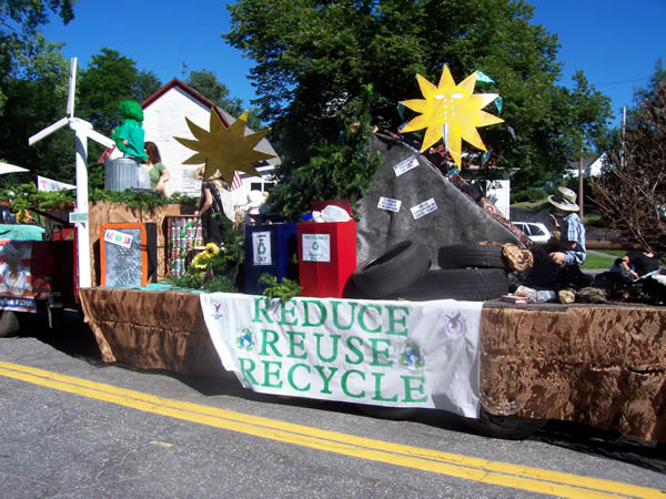 float with wind tower, recycling containers and solar tools