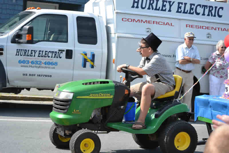 John Deere tractor driven by guy in funny glasses and hat
