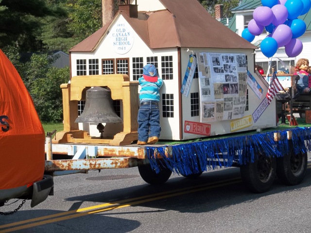 model of old high school being pulled as a float