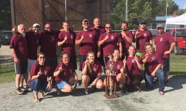 winning softball team posing with trophy