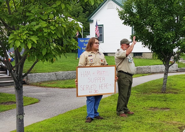 boyschouts holding bean supper sign