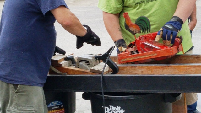 belt sander with carved wooden rooster ornament