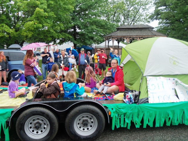 girls around campfire float