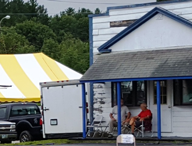 two men sitting on porch