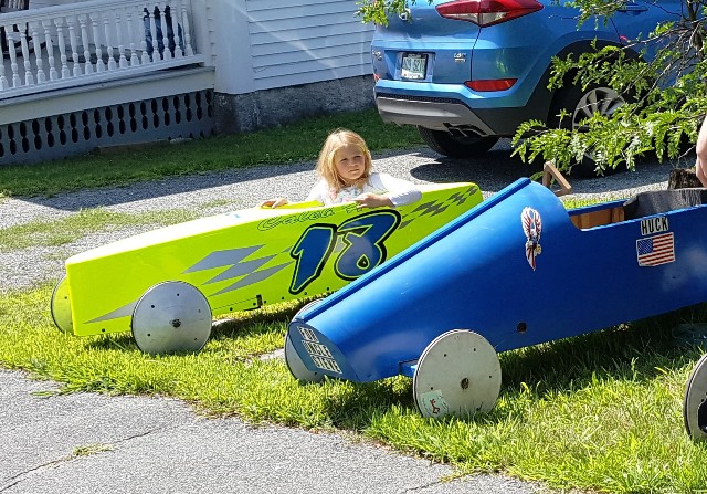 girl in soap box derby car