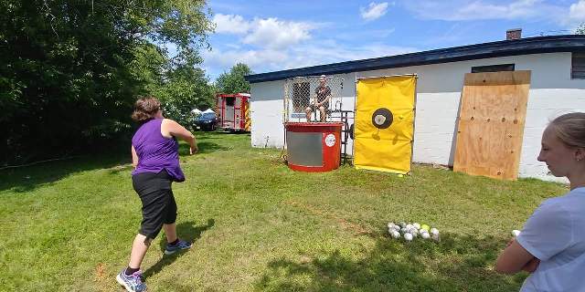 woman throwing at dunk tank
