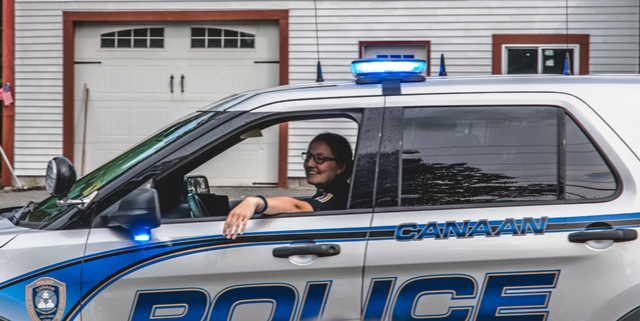 smiling police woman in car