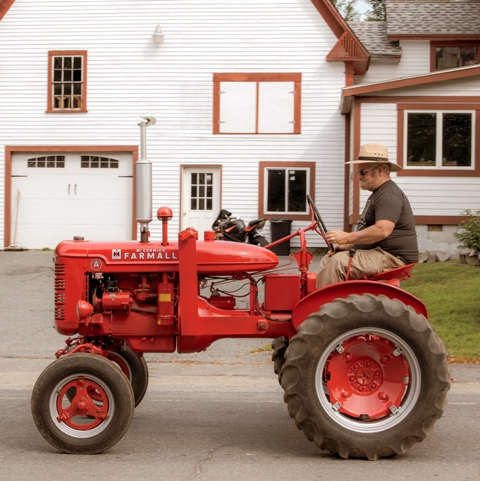 local farmer driving tractor