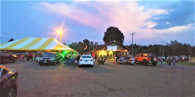 twilight sky over festive tent and buildings